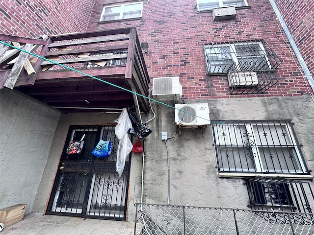 view of property featuring ac unit and fence