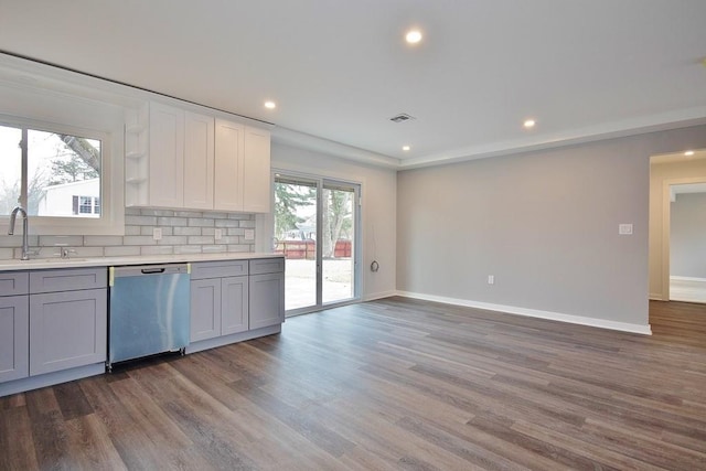 kitchen featuring gray cabinets, light countertops, visible vents, a sink, and dishwasher