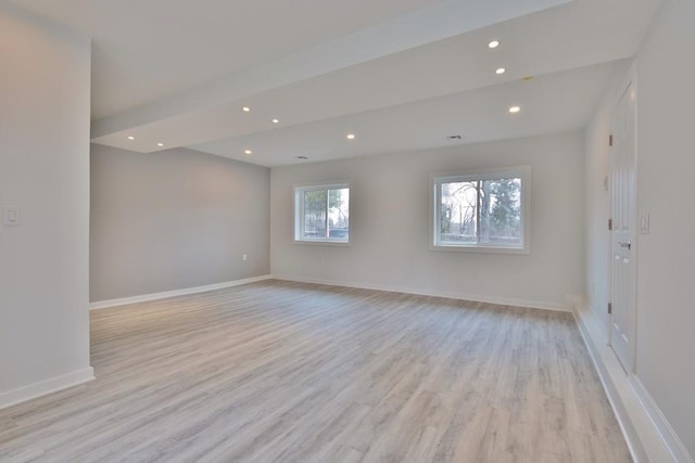 unfurnished room with baseboards, recessed lighting, and light wood-style floors