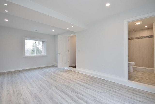 empty room with baseboards, light wood-type flooring, and recessed lighting