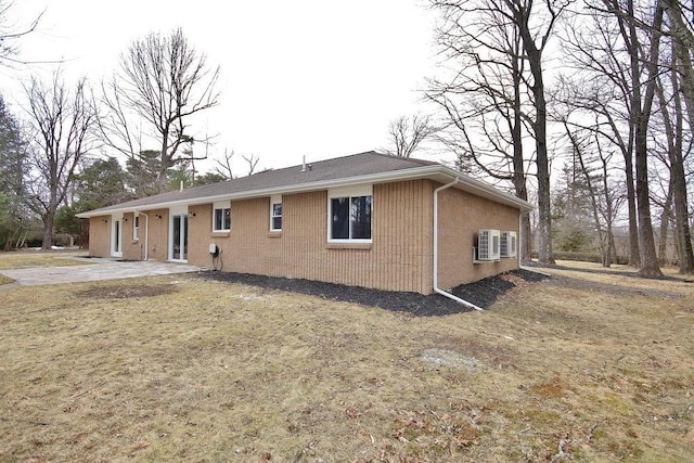 exterior space with a patio area and brick siding