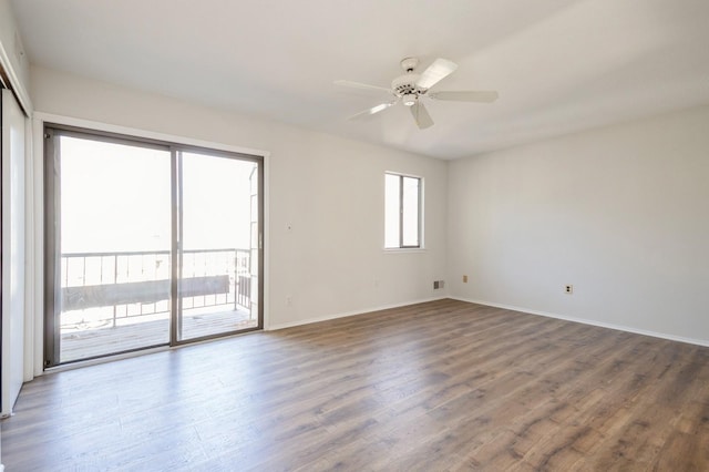 unfurnished room featuring baseboards, ceiling fan, and wood finished floors