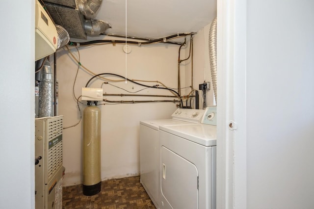 clothes washing area with independent washer and dryer and laundry area