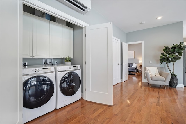 clothes washing area with recessed lighting, light wood-type flooring, cabinet space, and separate washer and dryer