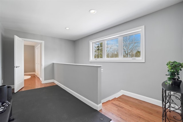 exercise area featuring recessed lighting, baseboards, and wood finished floors