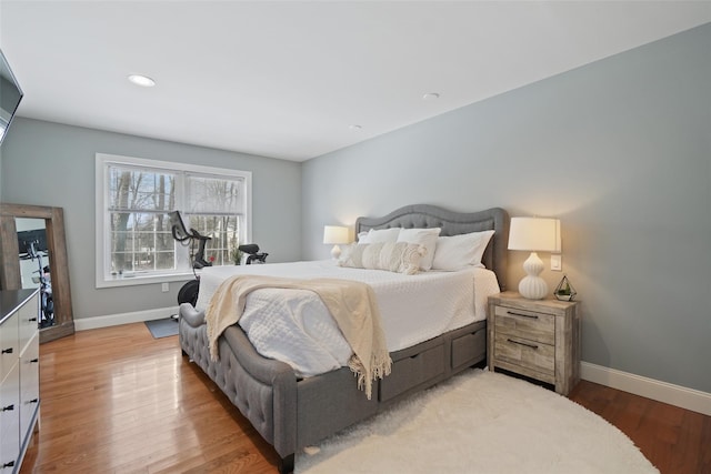 bedroom with recessed lighting, baseboards, and wood finished floors