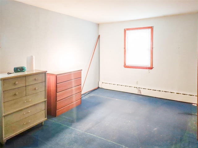 unfurnished room with a baseboard heating unit and finished concrete flooring