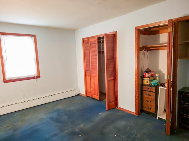 unfurnished bedroom with concrete flooring and a baseboard radiator