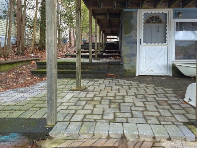 property entrance featuring a patio area