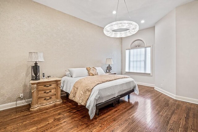 bedroom with baseboards, dark wood finished floors, and recessed lighting