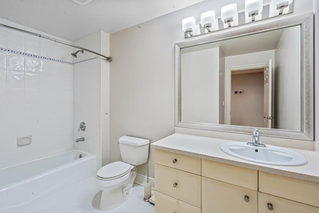 bathroom featuring tile patterned flooring, bathtub / shower combination, vanity, and toilet