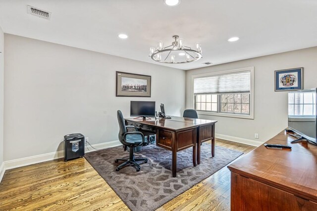 home office featuring baseboards, wood finished floors, visible vents, and recessed lighting