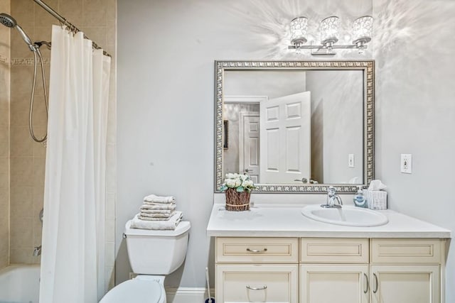 bathroom featuring tiled shower / bath combo, toilet, and vanity