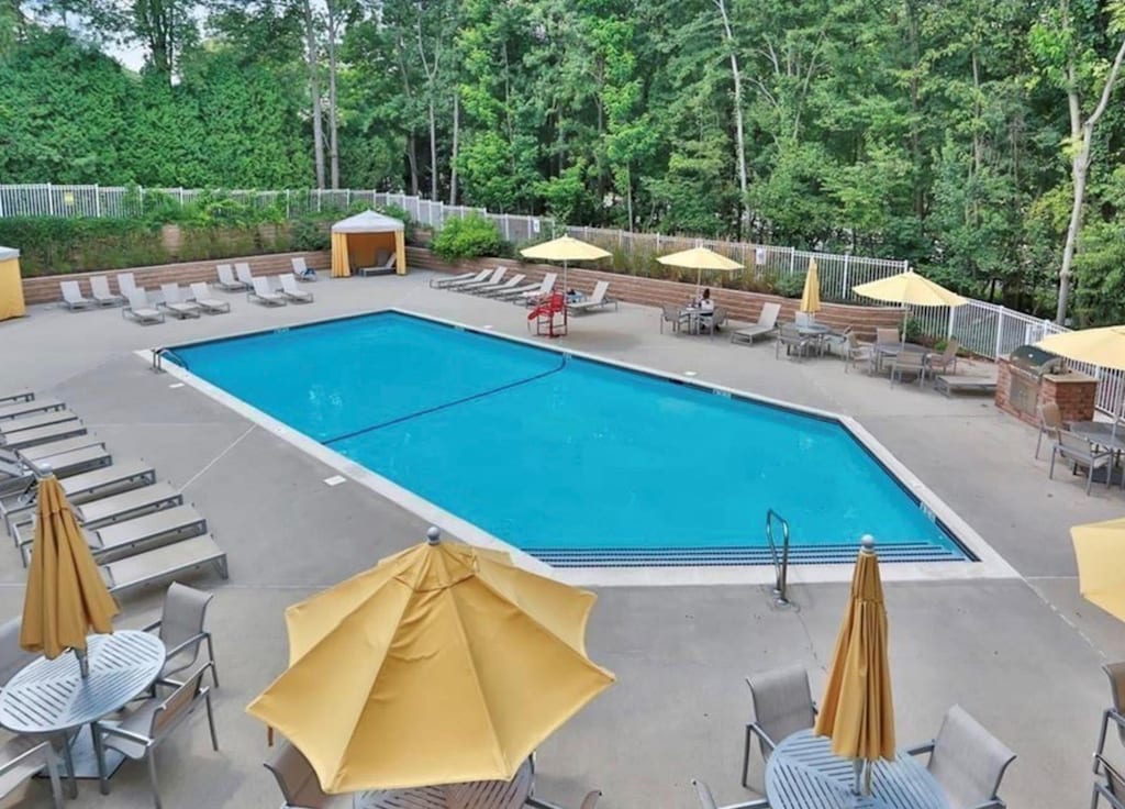 pool featuring a patio area and fence