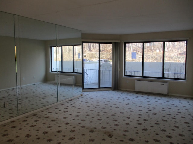 carpeted empty room with baseboards