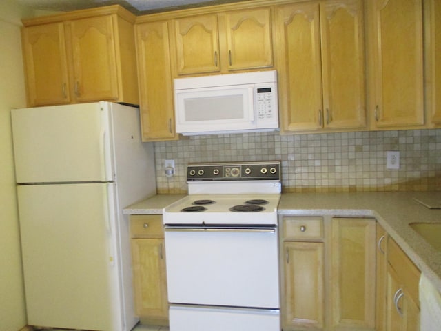 kitchen with white appliances and backsplash