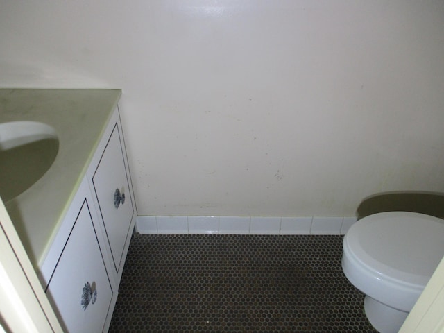 bathroom featuring toilet, tile patterned flooring, and vanity