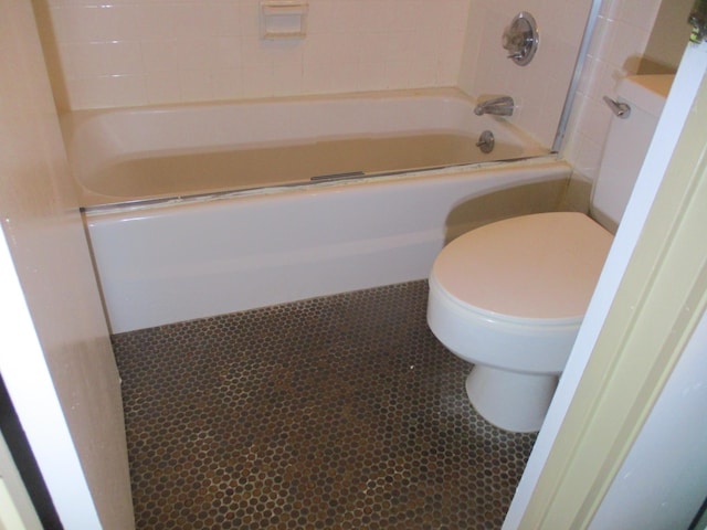 bathroom with toilet, tile patterned floors, and shower / bathtub combination