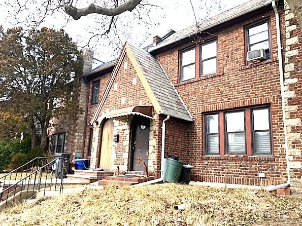 view of front of home featuring cooling unit and brick siding