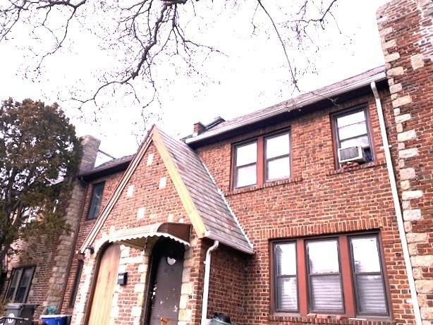 exterior space with brick siding and cooling unit