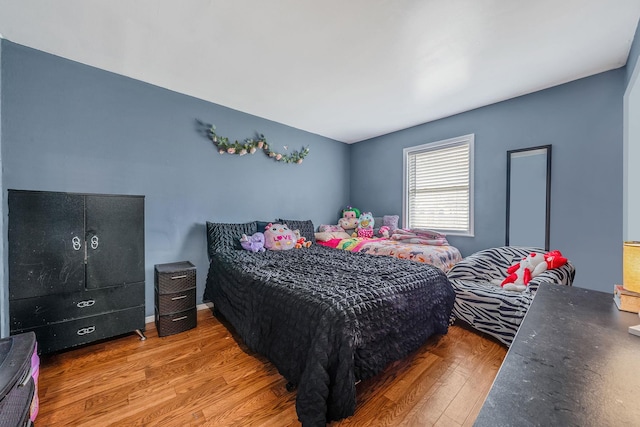 bedroom with wood finished floors