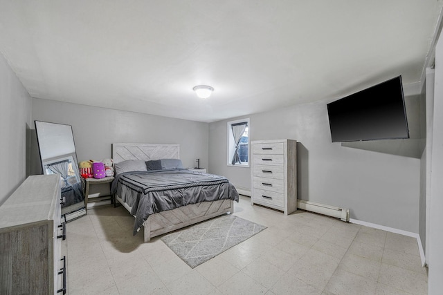 bedroom featuring light floors, a baseboard radiator, and baseboards