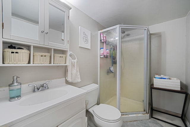 bathroom featuring a stall shower, vanity, and toilet