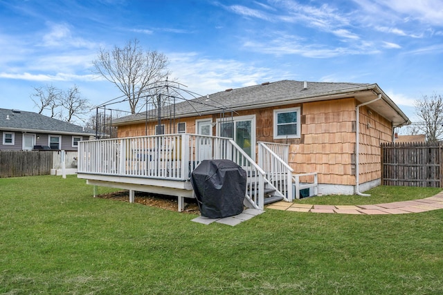 back of property featuring a fenced backyard, a lawn, and a deck