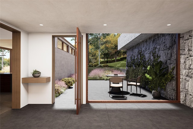 doorway with recessed lighting and expansive windows