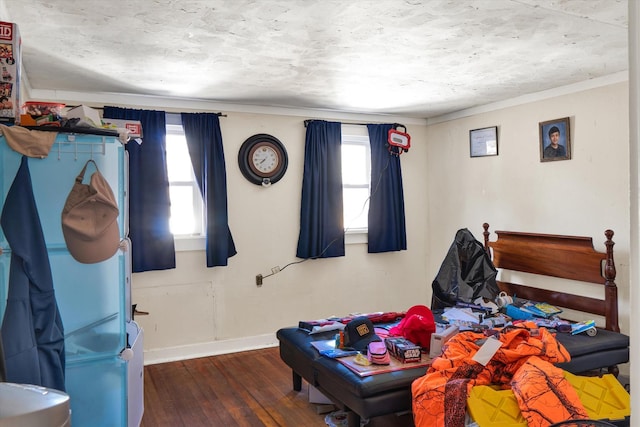 bedroom featuring multiple windows, hardwood / wood-style flooring, and baseboards