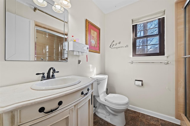 bathroom featuring toilet, a shower with door, baseboards, and vanity