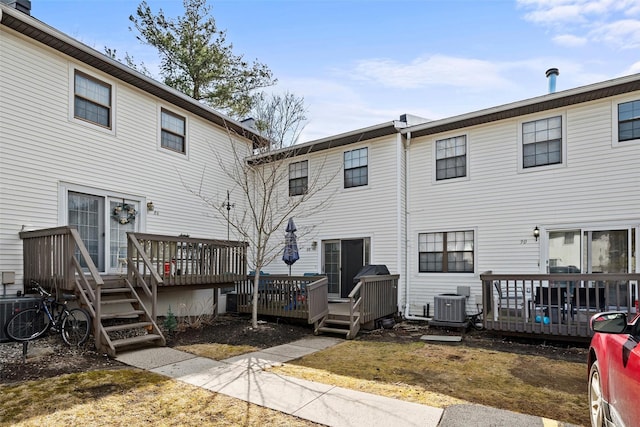 rear view of property with central air condition unit and a deck