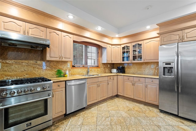 kitchen with light brown cabinets, appliances with stainless steel finishes, extractor fan, and a sink