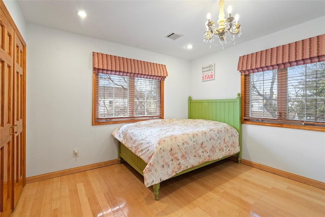 bedroom featuring baseboards, visible vents, wood finished floors, and recessed lighting