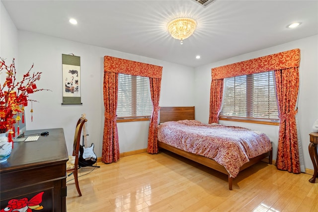 bedroom with light wood-type flooring, baseboards, and recessed lighting