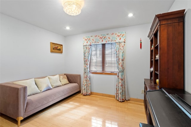 living area featuring a notable chandelier, recessed lighting, baseboards, and light wood-style floors