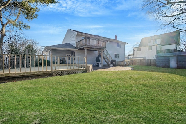 back of house with fence, a yard, stairway, a wooden deck, and a chimney