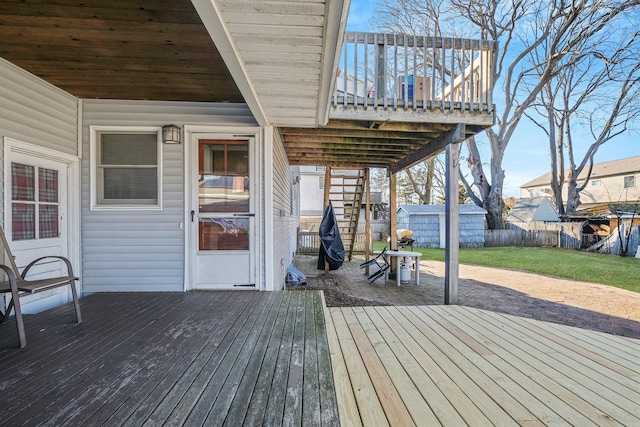 wooden terrace with a fenced backyard and a yard