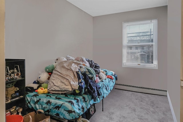 carpeted bedroom featuring a baseboard heating unit