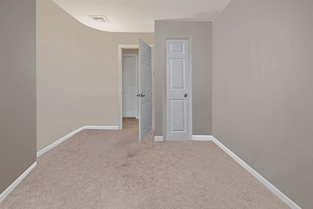 unfurnished bedroom featuring carpet floors, visible vents, and baseboards