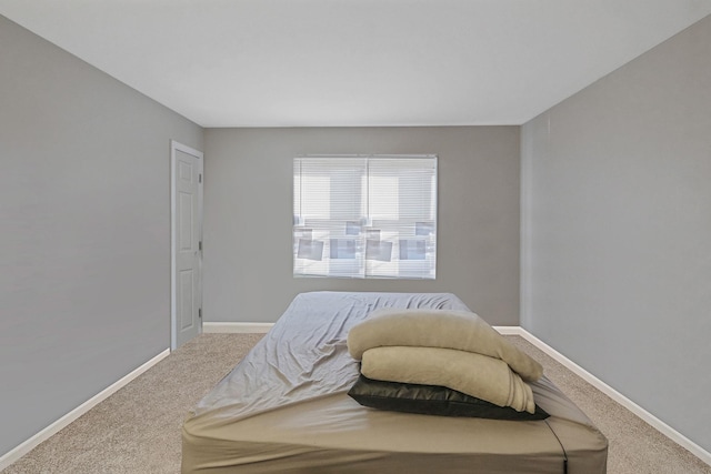 carpeted bedroom with baseboards