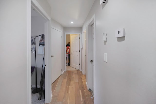 hall with recessed lighting and light wood-style floors