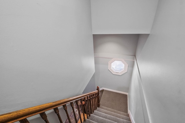 staircase featuring carpet and baseboards