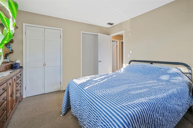 bedroom featuring visible vents and light colored carpet