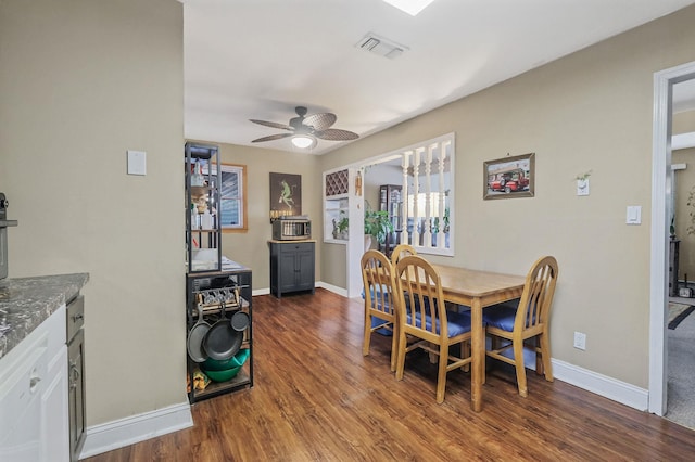 dining area with a ceiling fan, wood finished floors, visible vents, and baseboards