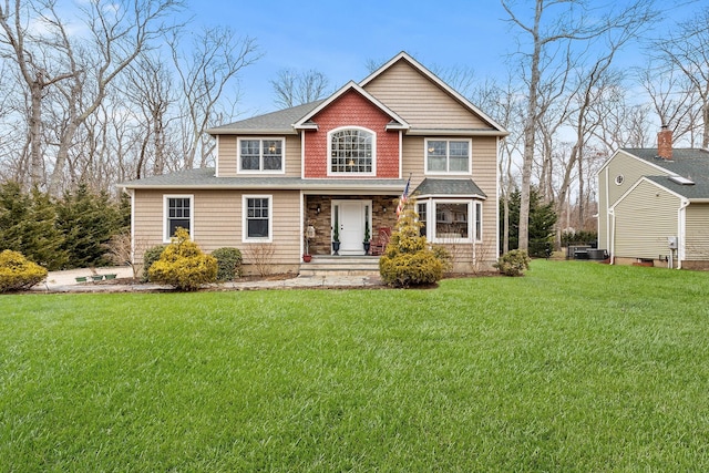 380 Hickory Rd, Southold, NY 11971 - view of front of house featuring central AC and a front lawn
