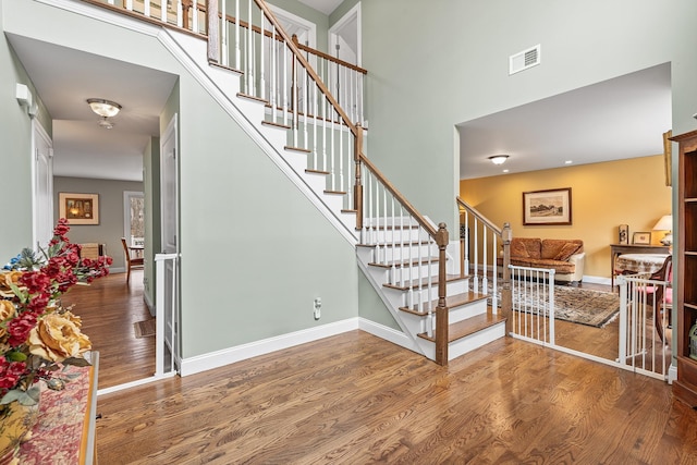 380 Hickory Rd, Southold, NY 11971 - stairway with visible vents, baseboards, a high ceiling, and wood finished floors