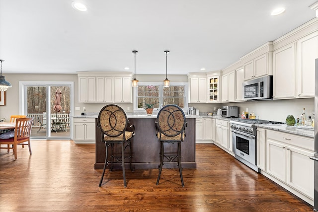380 Hickory Rd, Southold, NY 11971 - kitchen with recessed lighting, stainless steel appliances, a breakfast bar area, and dark wood-style floors