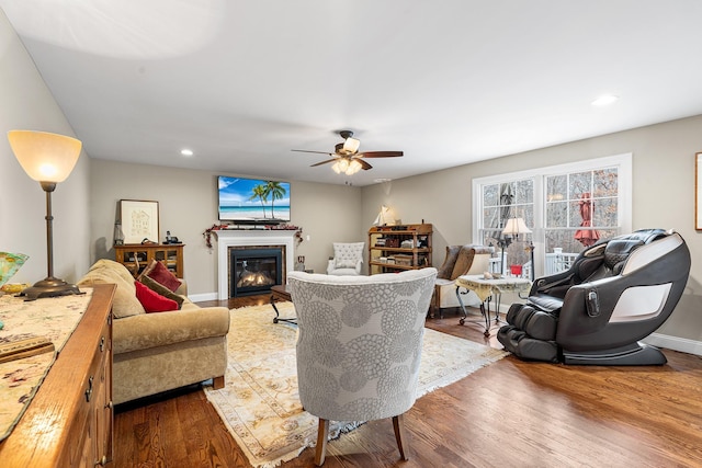 380 Hickory Rd, Southold, NY 11971 - living room with a glass covered fireplace, recessed lighting, baseboards, and wood finished floors