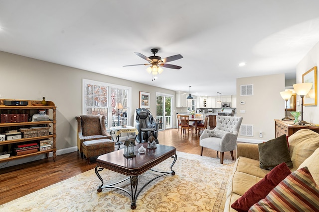 380 Hickory Rd, Southold, NY 11971 - living area featuring visible vents, baseboards, and wood finished floors